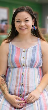 A smiling young woman kneeling