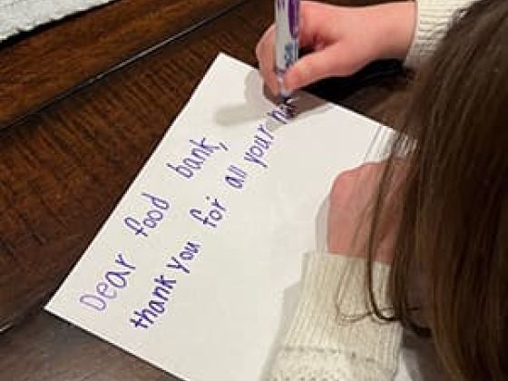 Kid writing a letter.